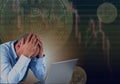 Frustrated stressed failed business man sitting with laptop with financial market chart graphic going down. Poor economy concept. Royalty Free Stock Photo