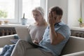 Frustrated stressed senior couple paying expensive bills