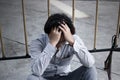 Frustrated stressed young Asian business man covering forehead with hands and feeling disappointed at outside office. Royalty Free Stock Photo