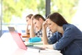 Frustrated students learning on line in a classroom Royalty Free Stock Photo