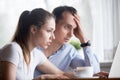 Frustrated surprised spouses looking at computer screen Royalty Free Stock Photo