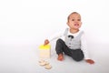 Frustrated toddler boy playing with Montessori toy for toddlers - piggy bank