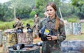 Frustrated young woman losing paintball match, standing with protective mask with splash of paint Royalty Free Stock Photo