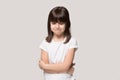 Frustrated upset lonely little girl isolated on grey studio background
