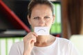 Frustrated woman covered her mouth with paper with sad emoticon. Royalty Free Stock Photo