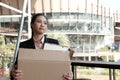 frustrated woman holding cardboard box containing personal belongings after being fired & layoff by employer. resignation concept Royalty Free Stock Photo