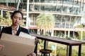 frustrated woman holding cardboard box containing personal belongings after being fired & layoff by employer. resignation concept Royalty Free Stock Photo