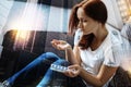 Frustrated woman looking at the pills in her hand and feeling bad Royalty Free Stock Photo