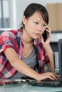 Frustrated woman on phone talking to customer Royalty Free Stock Photo