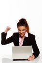 Frustrated woman punching her laptop Royalty Free Stock Photo