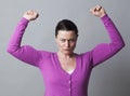 Frustrated woman showing her strong muscles for independence