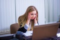 Frustrated worried young woman looks at laptop upset by bad news, teenager feels shocked afraid reading negative bullying message,