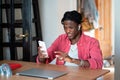 Frustrated young African self-employed man getting unexpected bad news while working from home Royalty Free Stock Photo