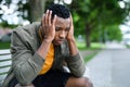 Frustrated young black man sitting on bench outdoors in city, black lives matter concept. Royalty Free Stock Photo