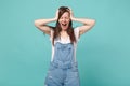 Frustrated young brunette woman in casual denim clothes posing isolated on blue turquoise background. People lifestyle Royalty Free Stock Photo