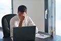 Frustrated young business man working on laptop computer at home Royalty Free Stock Photo