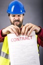 Frustrated young engineer with hardhat and reflective vest tear Royalty Free Stock Photo