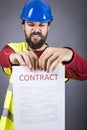 Frustrated young engineer with hardhat and reflective vest tear Royalty Free Stock Photo