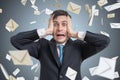 Frustrated young man and many falling envelopes. Many e-mails and spam concept. Royalty Free Stock Photo