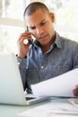 Frustrated Young Man On Phone Using Laptop At Home Royalty Free Stock Photo