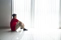 Frustrated young man sitting alone near the window Royalty Free Stock Photo