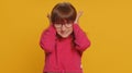 Frustrated young school girl kid covering ears ignoring unpleasant noise loud voices avoiding advice Royalty Free Stock Photo