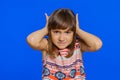 Frustrated young school girl kid covering ears ignoring unpleasant noise loud voices avoiding advice Royalty Free Stock Photo