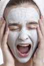 Frustrated young woman with face pack screaming against white background Royalty Free Stock Photo