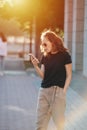 Frustrated young woman with gaping mouth looking at her phone. Royalty Free Stock Photo