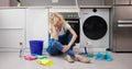 Frustrated Young Woman Sitting On Kitchen Floor Royalty Free Stock Photo