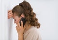 Frustrated young woman talking mobile phone Royalty Free Stock Photo