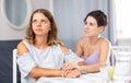 Frustration woman sitting at home and her partner asking to forgive after argument
