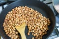 Fry hazelnuts in a frying pan. fresh nuts in the pan. Royalty Free Stock Photo
