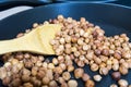 Fry hazelnuts in a frying pan. fresh nuts in the pan. Royalty Free Stock Photo