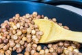 Fry hazelnuts in a frying pan. fresh nuts in the pan. Royalty Free Stock Photo