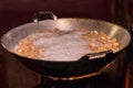 Fry the pork skin in a large frying pan on the stove Royalty Free Stock Photo
