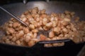 Fry the pork skin in a large frying pan on the stove Royalty Free Stock Photo