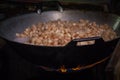 Fry the pork skin in a large frying pan on the stove Royalty Free Stock Photo