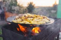 Fry potatoes on open fire in the open air