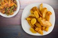 Fry potatoes on a wooden background