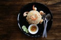 Fry rice with prawn in black dish on dark brown table,spoon, for Royalty Free Stock Photo