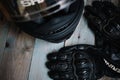 Fryazino, Russia - 06 18 2018: motorcycle rider accessories. helmet and gloves on wooden table, top view