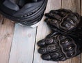 Fryazino, Russia - 06 18 2018: motorcycle rider accessories. helmet and gloves on wooden table, top view