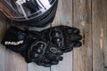 Fryazino, Russia - 06 18 2018: motorcycle rider accessories. helmet and gloves on wooden table, top view