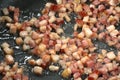 Frying bacon to make greaves. Royalty Free Stock Photo