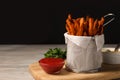 Frying basket with sweet potato fries, sauces and parsley on table. Space for text Royalty Free Stock Photo