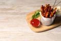 Frying basket with sweet potato fries, sauces and parsley on white wooden table. Space for text Royalty Free Stock Photo