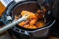 Frying BBQ chicken wings in a hot air fryer