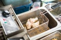 Frying chicken in the deep fryer Royalty Free Stock Photo