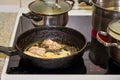 Frying chicken in a pan. Cooking potatoes. Royalty Free Stock Photo